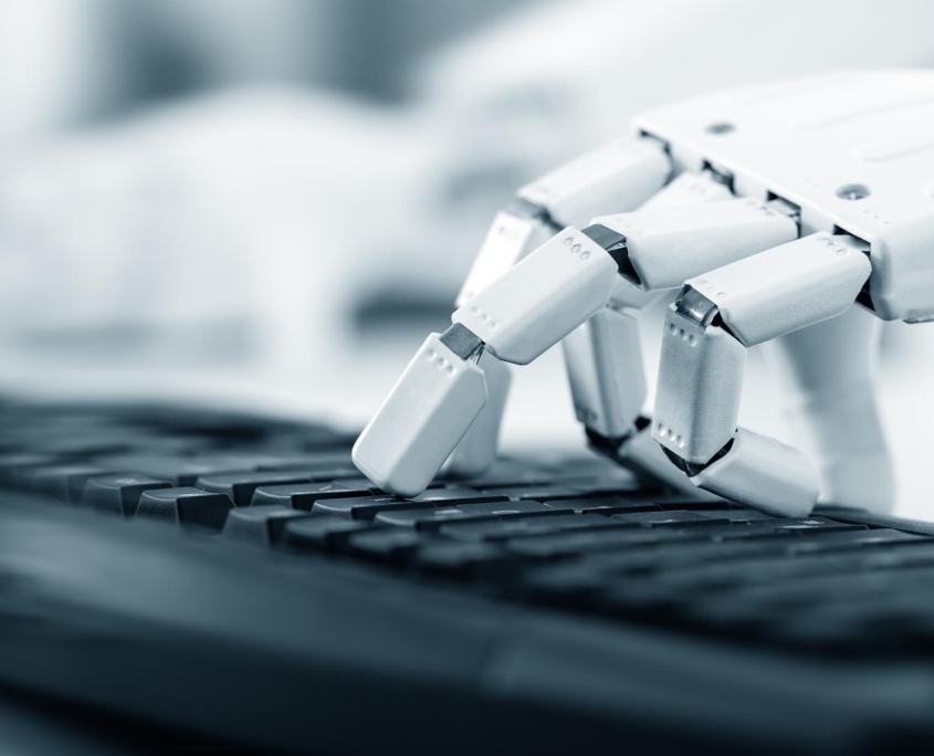 Robot typing on computer keyboard